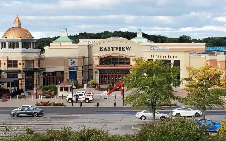 Exterior view of the Eastview shopping mall entrance with parked cars in the foreground, where a Heritage Christian Services hiring event is taking place.